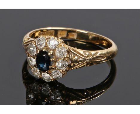 18 carat gold diamond and sapphire set ring, the head with a central oval sapphire and diamond surround, ring size O