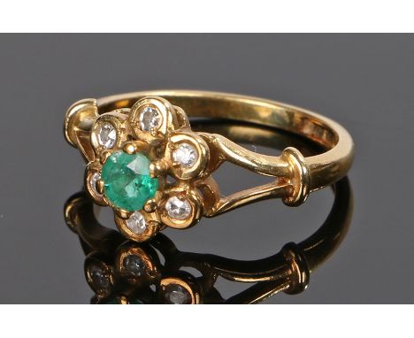 18 carat gold emerald and diamond set ring, the central round cut emerald with a diamond surround, ring size J