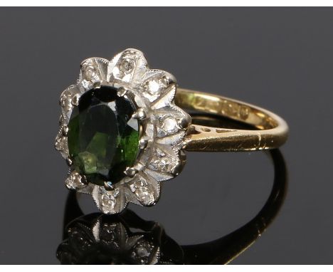 18 carat gold, green sapphire and diamond ring, the central green sapphire with a diamond surround, ring size J