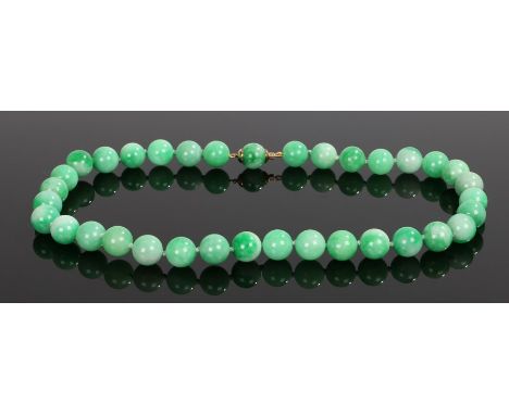 Jade necklace, with a row of jade beads each approximately 13mm diameter, 54cm long 