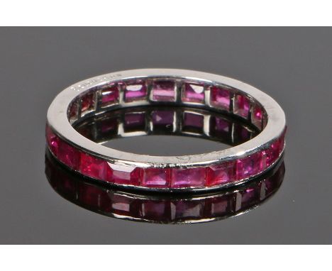Boucheron ruby set eternity ring, with a ruby surround to the white metal shank, signed Boucheron, ring size L