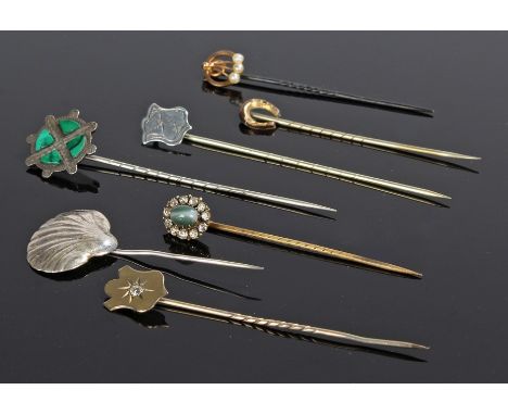 Stick pins, to include a shell, a malachite set example, two shield examples, a horse shoe and agate example, (7)