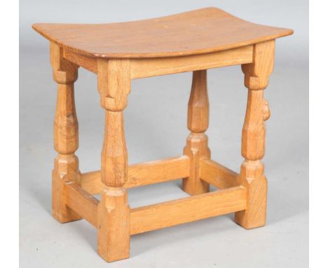 A Robert 'Mouseman' Thompson oak and walnut stool, the adzed concave top above octagonal baluster legs, one carved with mouse