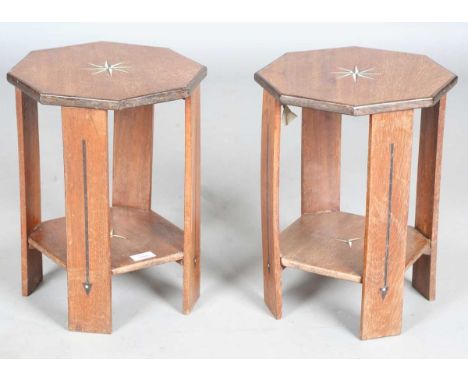 A pair of early 20th century Arts and Crafts hardwood two-tier occasional tables, in the manner of Liberty &amp; Co, the cant