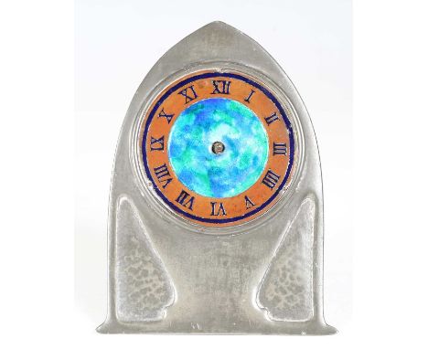 A Liberty &amp; Co 'Tudric' pewter timepiece, model number '0975', the lancet arched front with a blue/green mottled enamel d