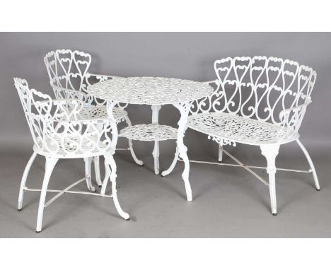 A 20th century white painted cast alloy garden table, height 77cm, diameter 78cm, together with a matching pair of chairs, he