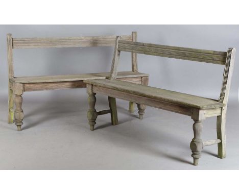 A pair of early 20th century hardwood hall benches with rail backs and solid seats, height 85cm, width 137cm, depth 37cm (wea