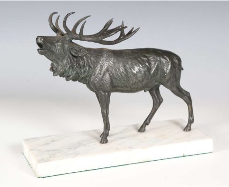 An early 20th century green patinated cast bronze model of a roaring stag, length 24cm, later mounted on a white marble plint