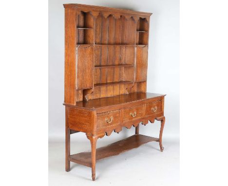 An early 20th century oak dresser, the plate rack above three drawers and a pot shelf, height 200cm, width 153cm, depth 51cm.