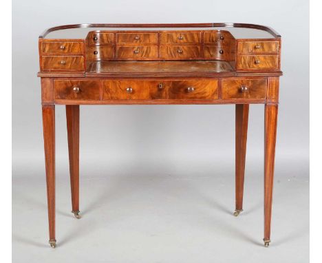 An early 20th century mahogany Carlton House style desk, the galleried back fitted with drawers above a pull-out writing surf