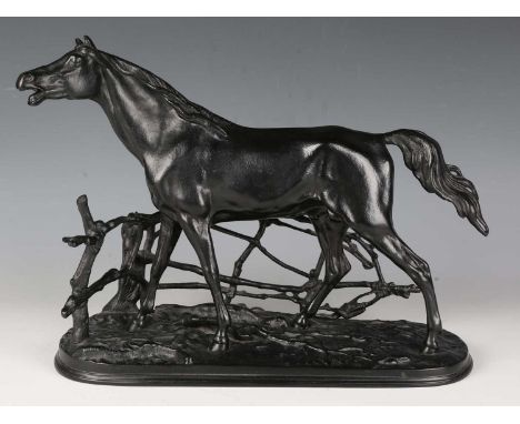 A 20th century Russian cast iron model of a horse standing by a rustic fence, the underside bearing maker's plaque, width 37c