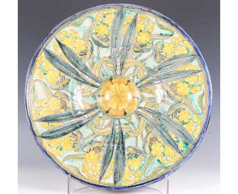 A large Della Robbia pottery charger by Charles Collis, circa 1900, the central domed boss with yellow flowerhead within a we