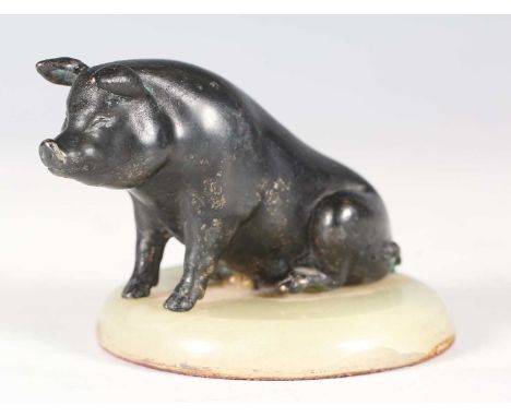 Georges Gardet - an early 20th century French black patinated cast bronze model of a seated pig, the circular onyx base beari