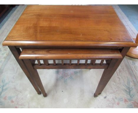 Graduated pair of oak rectangular lamp tables with galleried frieze on square tapered supports with spade feet, makers label 