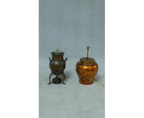 An antique twin handled copper samovar with glass finial and pierced legs along with a ceramic gold foiled and painted lamp b