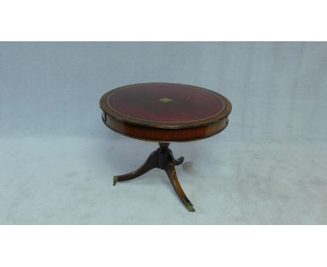 A Georgian style mahogany drum table with inset tooled leather top and opposing frieze drawers on tripod swept supports. H.72