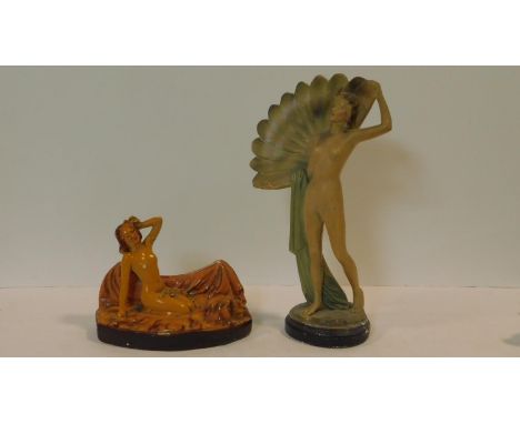 Two Art Deco ceramic painted nude flapper girls. One with a fan and the other lying on a bed with her hand to her brow. H.38c