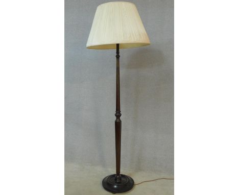 An early 20th century carved and turned mahogany standard lamp on circular base. H.178cm 