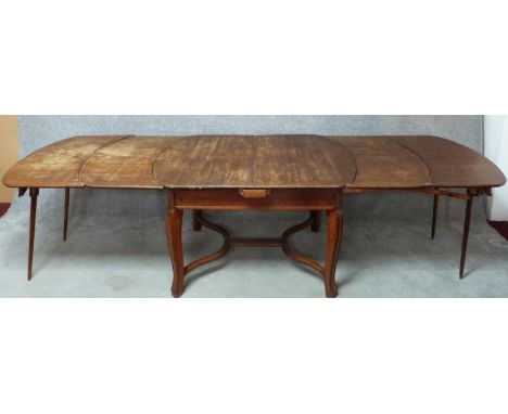 A vintage French oak extending dining table fitted with four extra leaves and integral end supports. H.78 W.360 D.96cm 