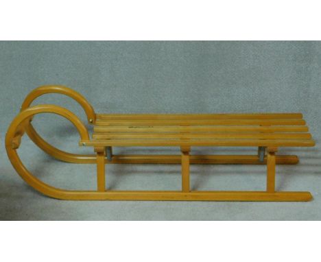 A German laminated beech wood sleigh by Ress Rodel in the vintage style with makers mark. H.37 W.116 D.35cm 