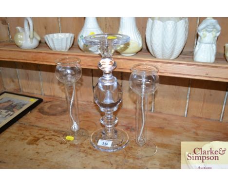 A glass candle stick and two glass oil lamps