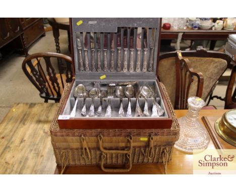 A canteen of "Kings" patterned cutlery; and a wicker picnic hamper