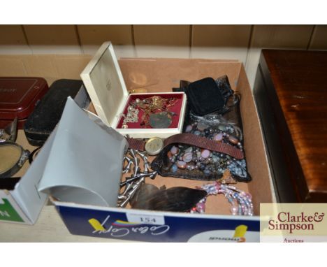 A box containing various costume jewellery to include a silver chain, white metal brooch, white metal fork etc,