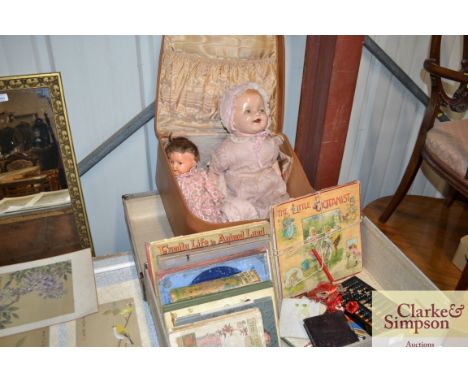 A suitcase containing various children's books; an abacus; a travelling chess set; and one other case and contents of two dol