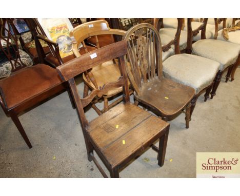 An oak bar back dining chair; and an elm seated stick and wheel back dining chair 