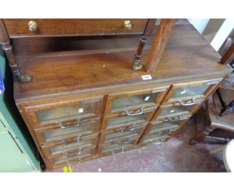 A 92cm vintage mixed wood multi-drawer haberdashery unit with three flights of four glass fronted drawers - later top