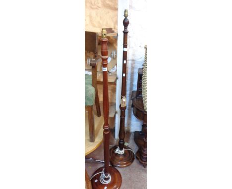 A vintage stained beech standard lamp - sold with a later stained wood similar, both with circular bases