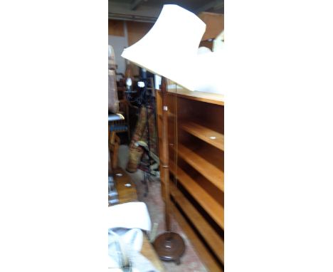 A 20th Century polished wood standard lamp with circular base and shade
