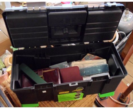 A plastic toolbox and contents including watches, books, etc.