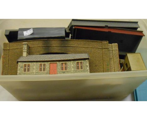 A box containing vintage model railway station buildings, etc.