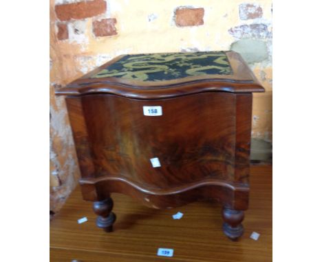 A Victorian mahogany serpentine front step commode with china liner, set on turned legs