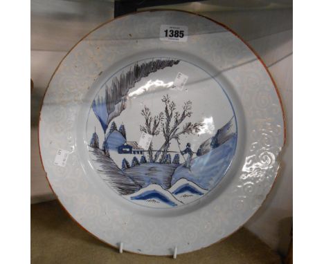 An 18th Century Bristol Delftware dish with central chinoiserie design painted in manganese and blue with bianco sopre bianco