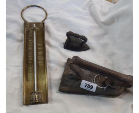 A 19th Century cast iron miniature flat iron - sold with a larger decorative similar and a brass sugar thermometer