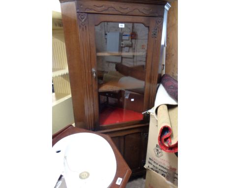 An 82cm vintage oak corner cabinet with glazed top and panelled door under