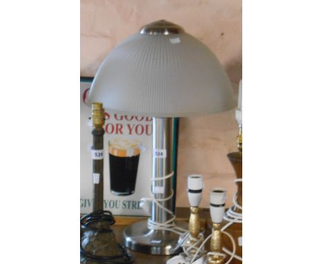 A modern brushed metal mid Century style table lamp with holophane style frosted shade