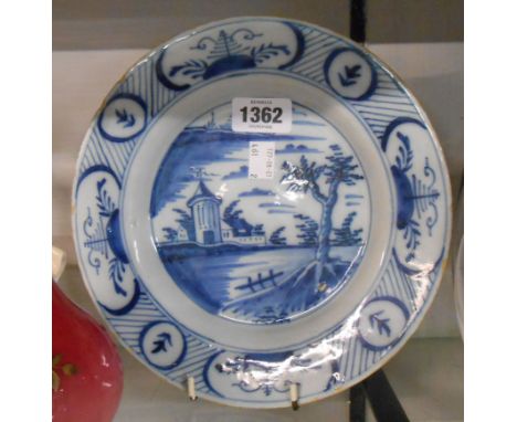An 18th Century English Delftware plate handpainted in blue with a rustic scene