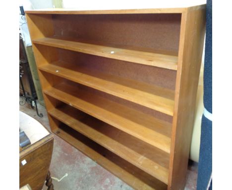 A 1.42m mixed wood five shelf open bookcase