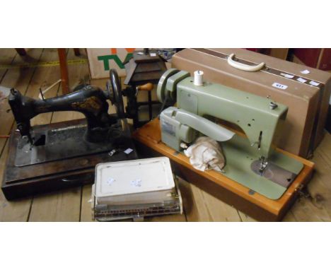 A vintage cased Jones electric sewing machine - sold with another sewing machine, an old scale and a wooden hanging wall lant