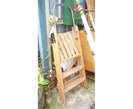 A small wooden step ladder with metal top rail