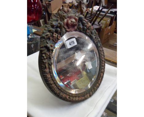 A small Barbola dressing table mirror with bevelled circular plate and easel back