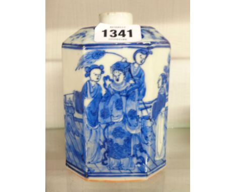 An antique Chinese porcelain tea canister decorated with figures on a palisade in a blue palette with four character seal mar