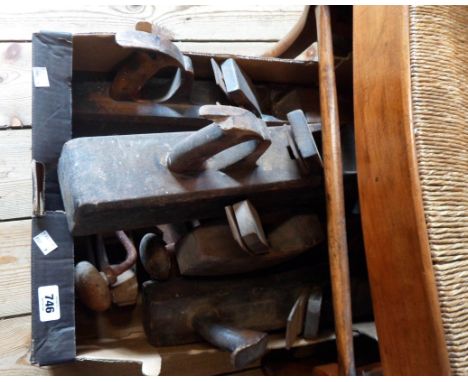 A box containing a quantity of old woodworking tools including planes, braces, etc.