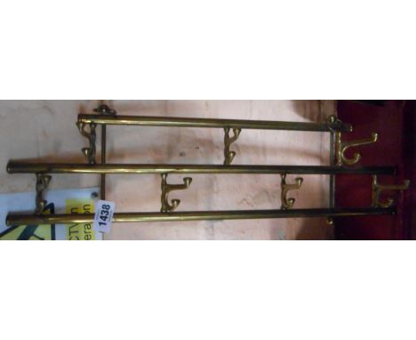 A vintage hanging brass folding coat hook
