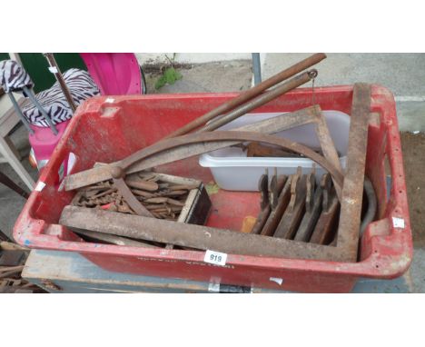 A crate containing woodworking tools including moulding planes, auger bits, set square, etc.