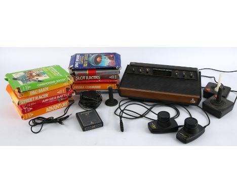 Atari 2600 console with 2 paddles, 2 classic joysticks, 12 boxed games and 1 loose game Games include: Superman, E.T. The Ext