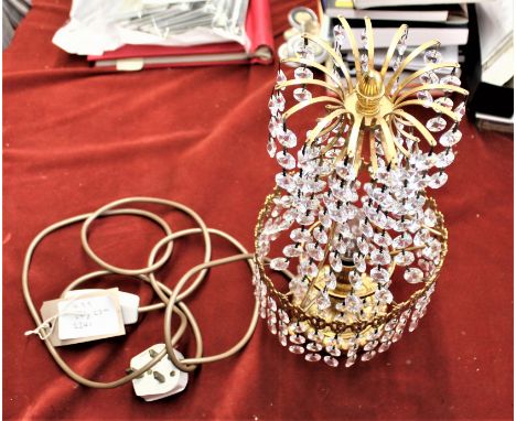 An vintage brass lamp with hanging crystal drop chandelier design, measures 14 1/2" by 6 3/4". 